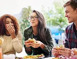 group of young adults enjoying lunch